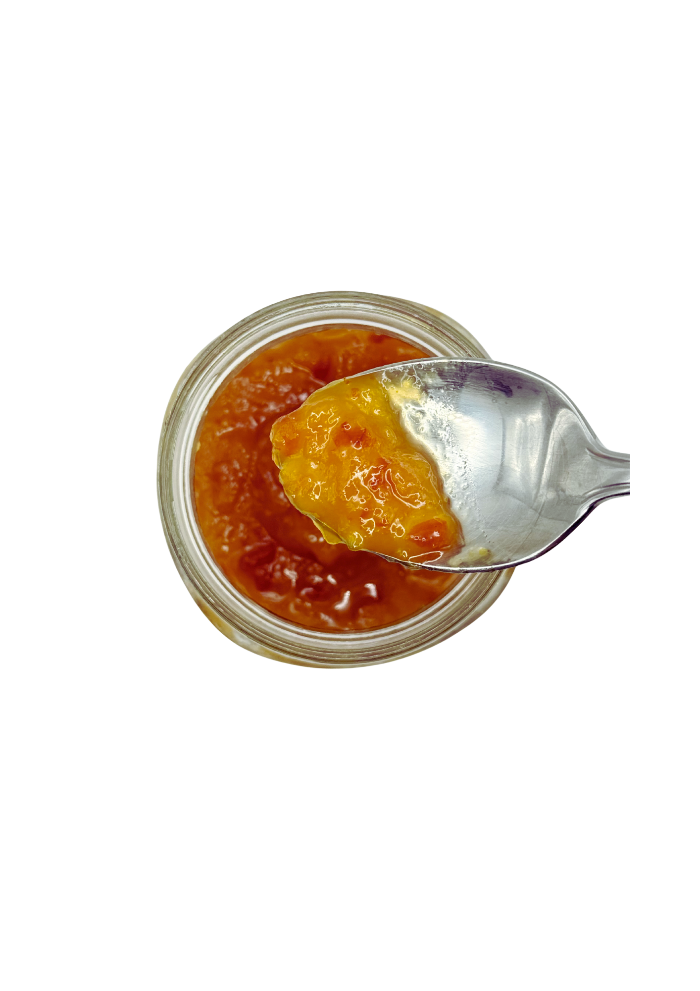 Jar of orange marmalade with a spoonful being lifted out on a white background